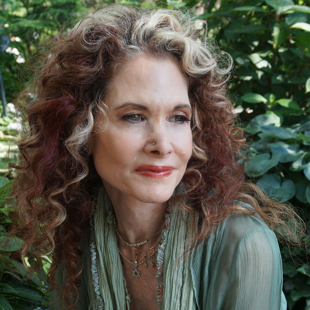 portrait of robyn posing in front of greenery